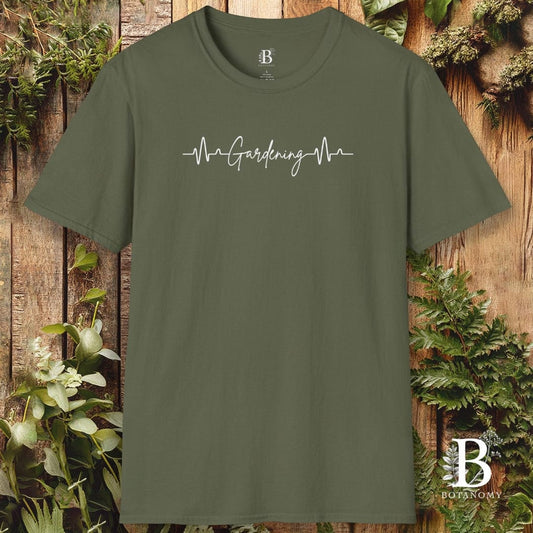 Green t-shirt with 'Gardening Mom' text on a wooden background with plants