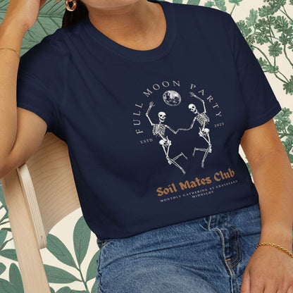 Person wearing a navy blue t-shirt with a graphic design sitting on a chair.