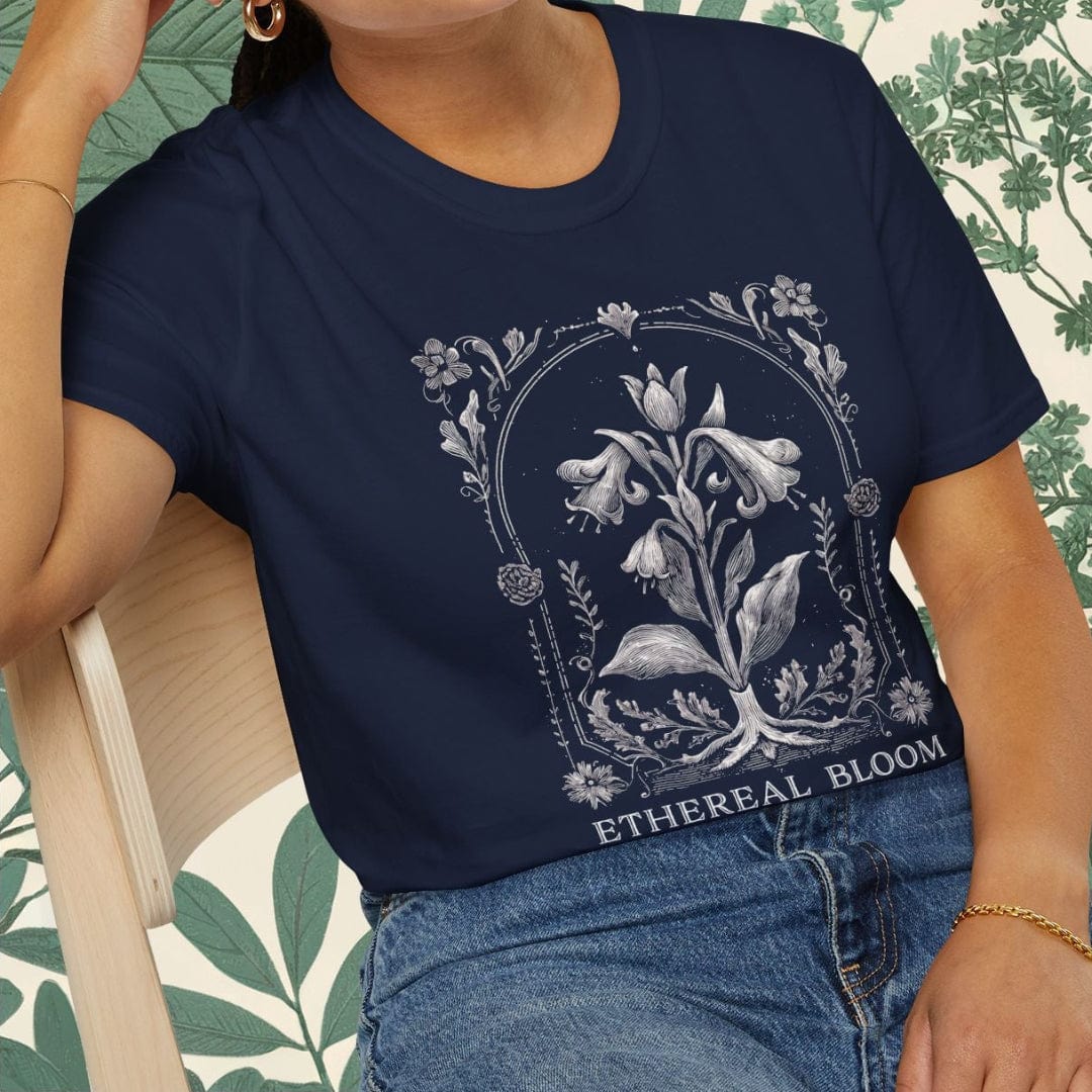 Woman wearing a navy blue t-shirt with floral design and text, sitting on a chair.