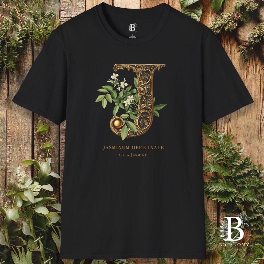 Black t-shirt with decorative letter 'J' design featuring jasmine on a wooden background.