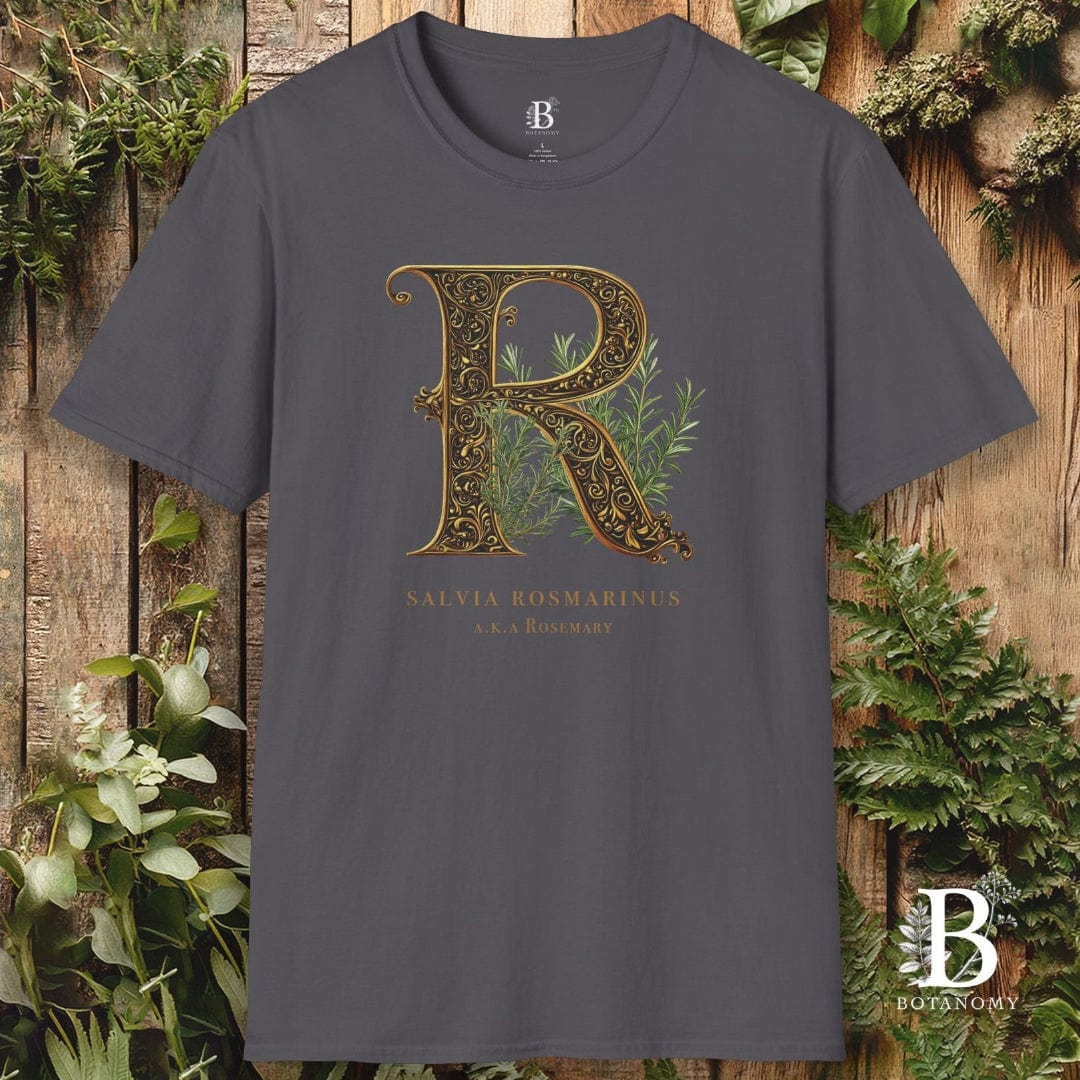 Gray t-shirt with decorative letter 'R' design on a wooden background with plants