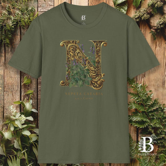 Green t-shirt with decorative letter 'N' design on a wooden background