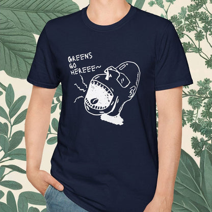 Man wearing a navy blue t-shirt with a graphic design and text, standing against a leafy background.