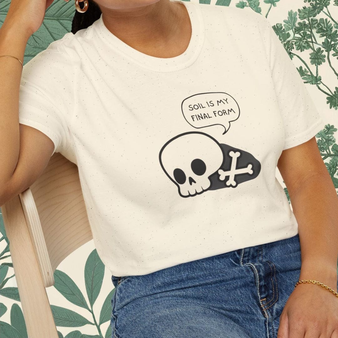 Woman wearing a white t-shirt with a skull design and text, sitting on a chair.