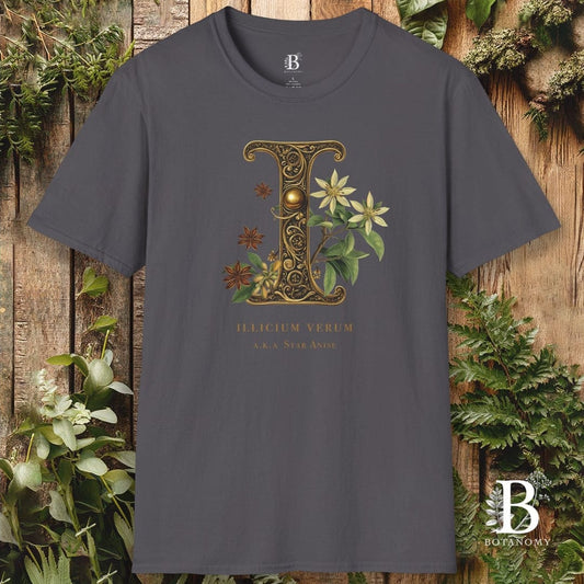 Gray t-shirt with decorative letter 'D' and floral design on a wooden background