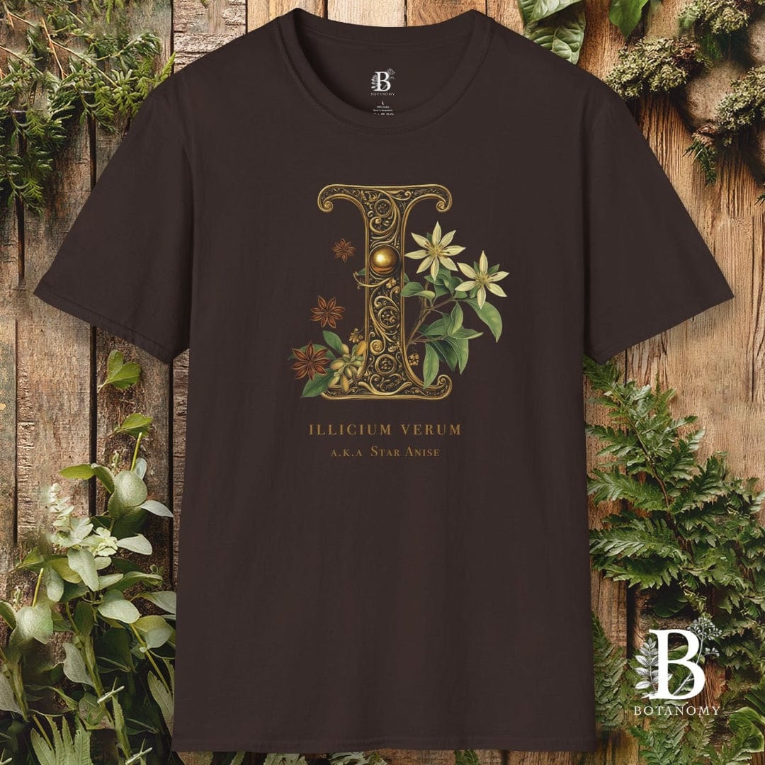Brown t-shirt with decorative letter 'E' design on a wooden background