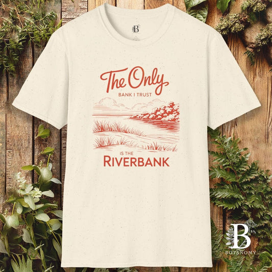 White t-shirt with red graphic and text on a wooden background