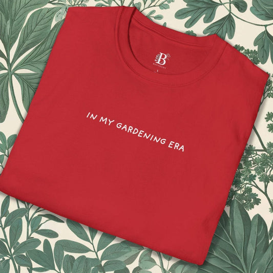 Red t-shirt with 'IN MY GARDENING ERA' text on a leaf-patterned background