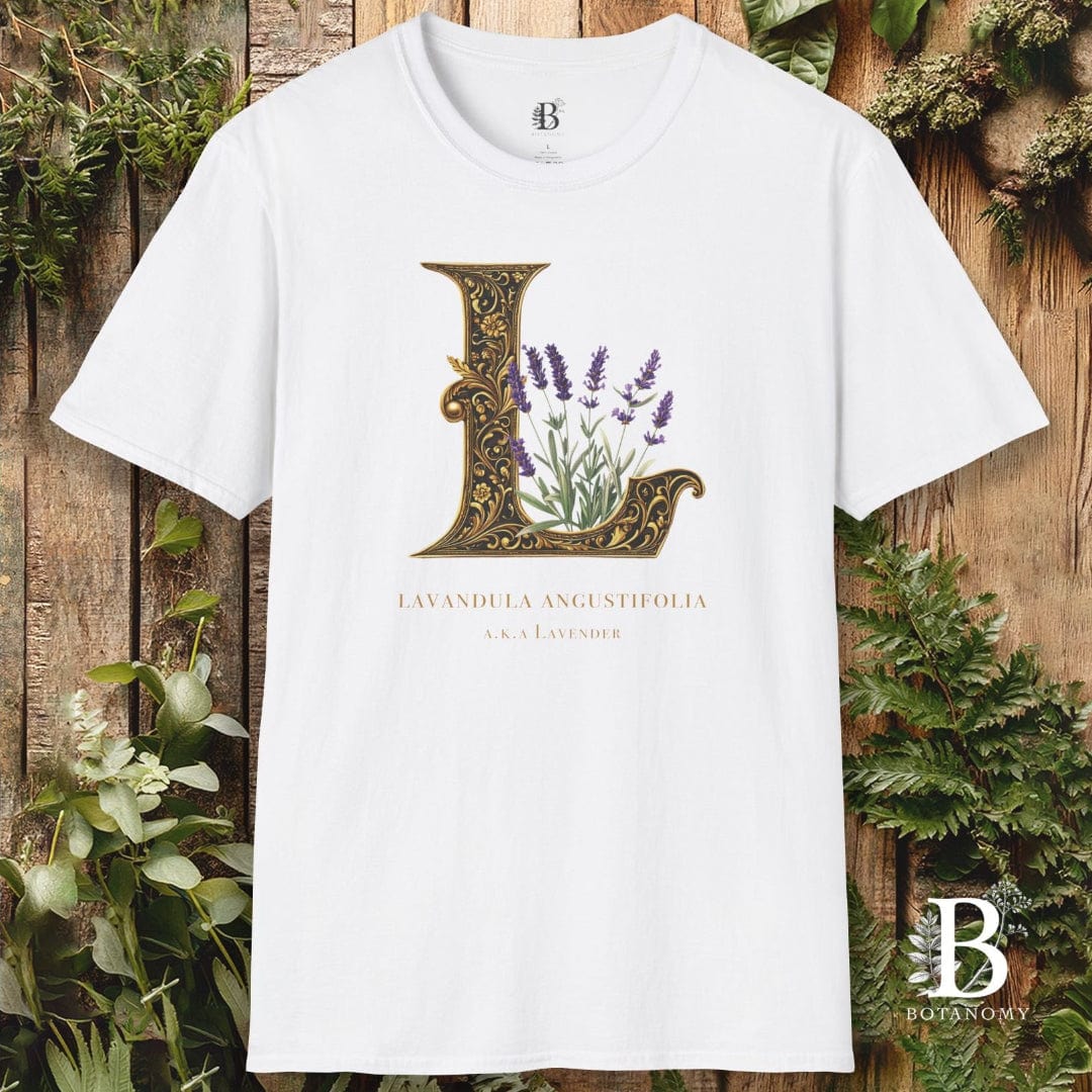 White t-shirt with decorative letter 'L' design featuring plants on a wooden background