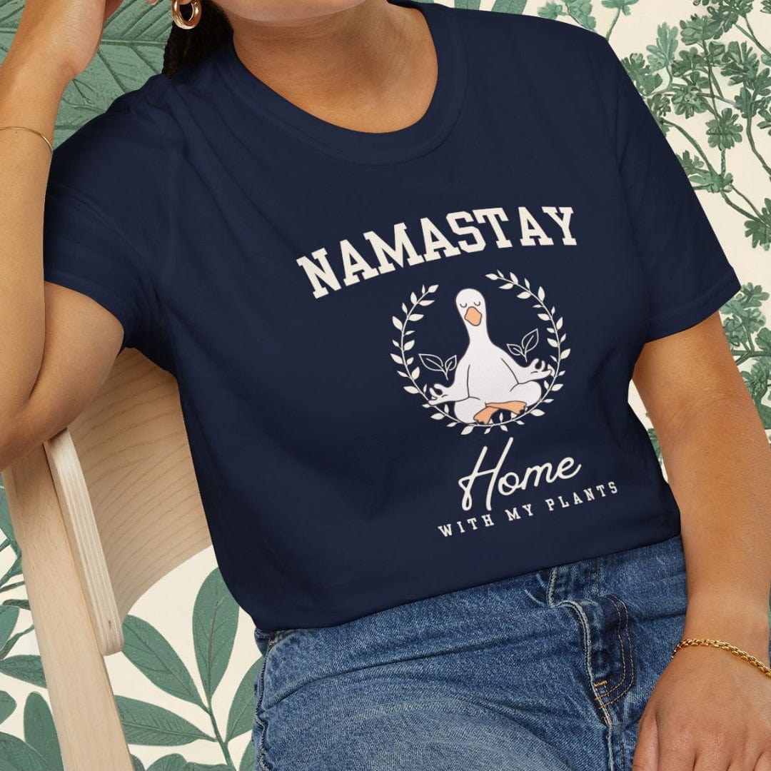 Person wearing a navy blue t-shirt with 'Namastay Home with My Plants' design.