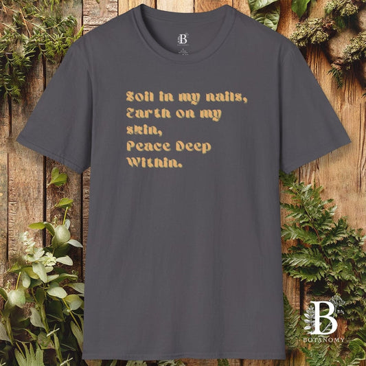Gray t-shirt with text design on a wooden background with plants
