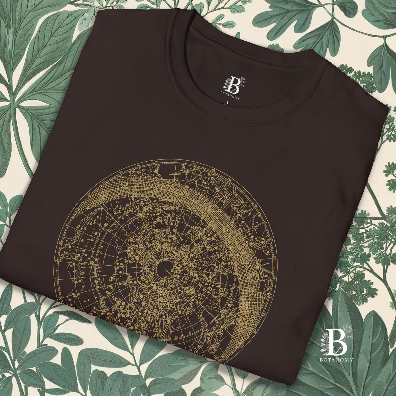 close up of folded brown t-shirt with constellation graphic design.