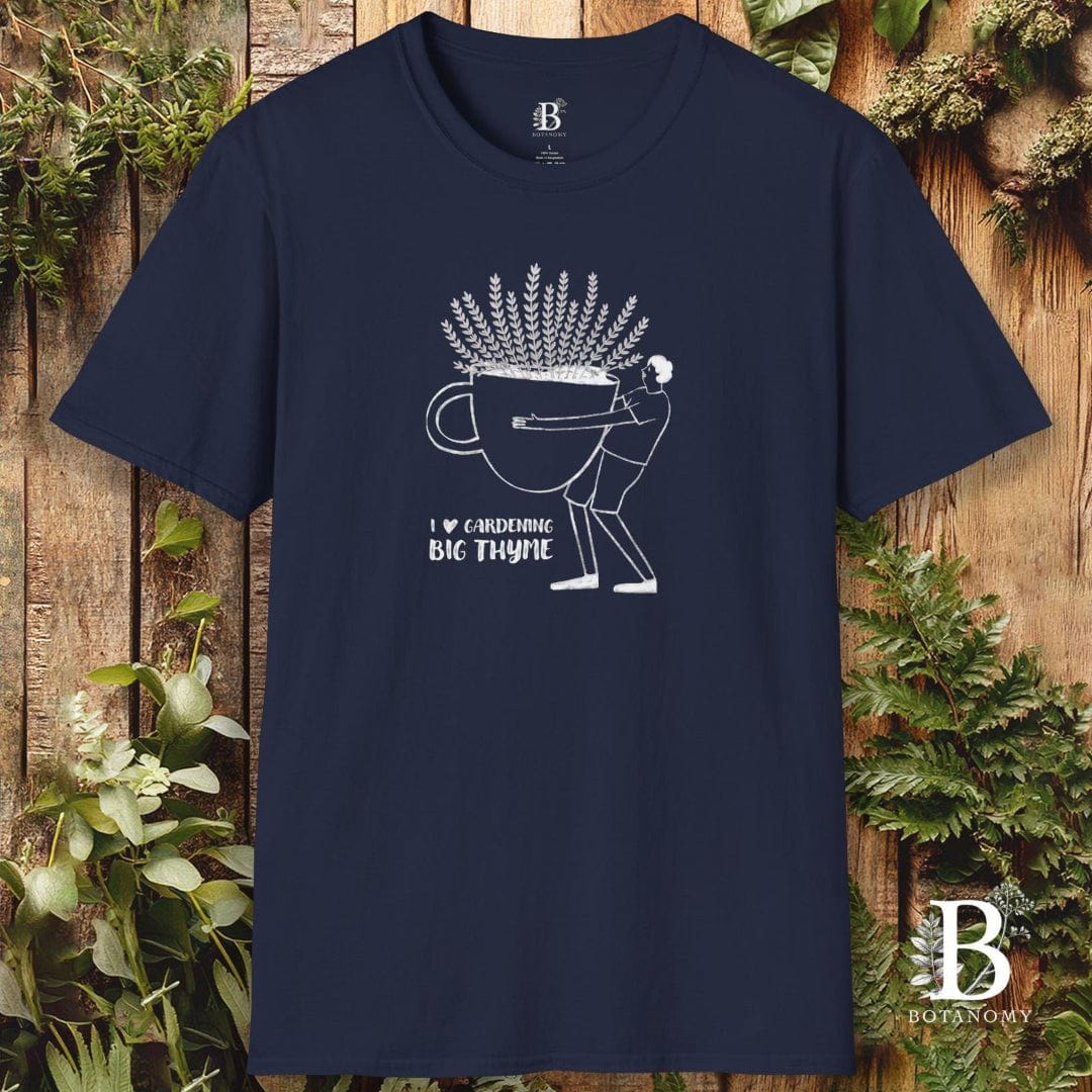 Navy blue t-shirt with white graphic design on a wooden background with plants