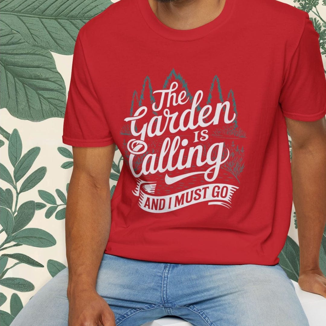 Man wearing a red t-shirt with 'The Garden is Calling and I Must Go' text, sitting against a white background with green plants.