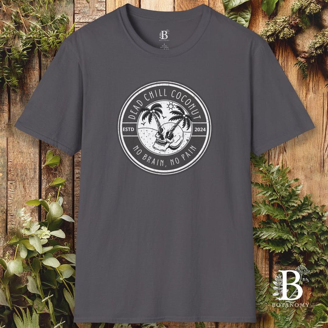 Gray t-shirt with a circular logo featuring a palm tree on a wooden background with greenery.