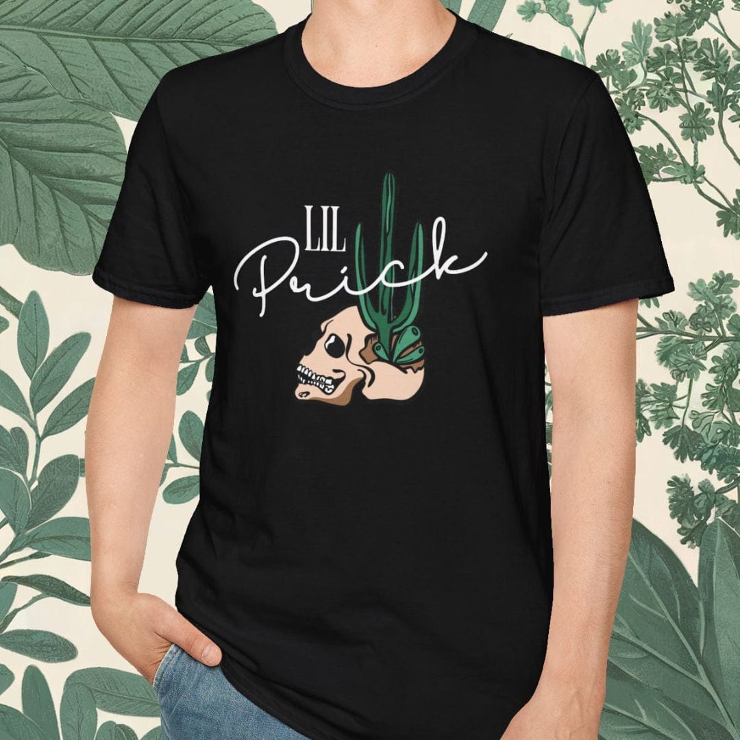 Person wearing a black t-shirt with a graphic design and text, standing against a leafy background.