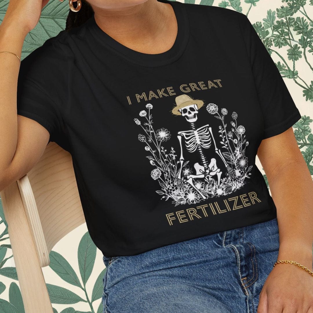 Person wearing a black t-shirt with a skeleton graphic and text, sitting on a chair.