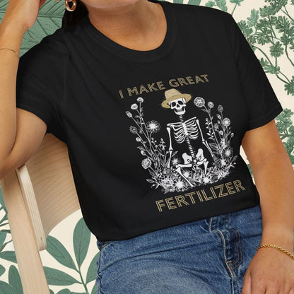 Person wearing a black t-shirt with a skeleton graphic and text, sitting on a chair.