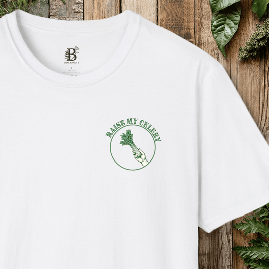 White t-shirt with 'Raise My Celery' design on a wooden background