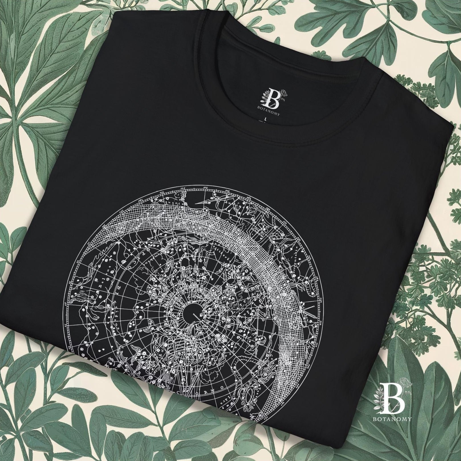 Black folded up close up of t-shirt with constellation graphic design.