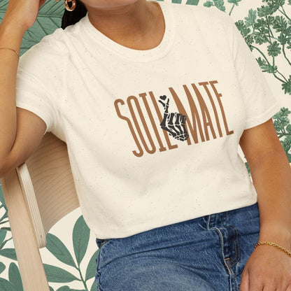 Woman wearing a white t-shirt with 'Soul Mate' printed on it, sitting on a chair.
