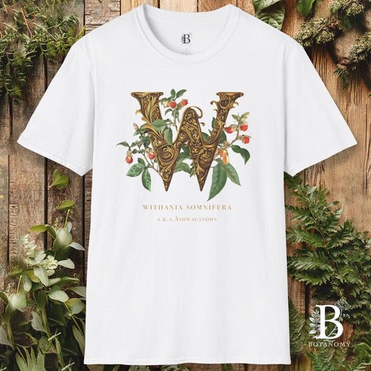 White t-shirt with decorative letter 'W' design on a wooden background