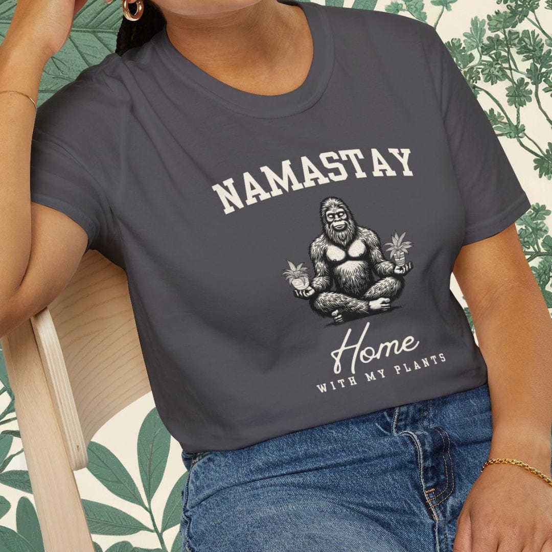 Person wearing a gray t-shirt with 'NAMASTAY Home With My Gorilla' design, sitting on a chair.