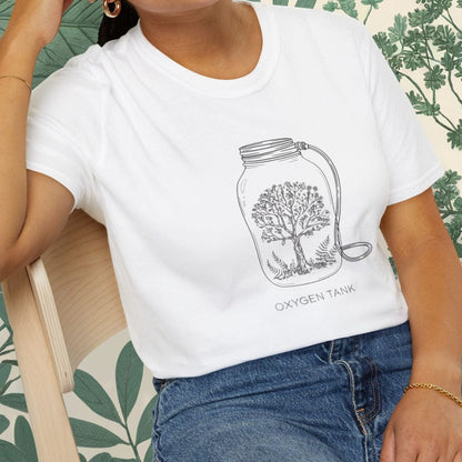 Person wearing a white t-shirt with a design sitting on a chair.