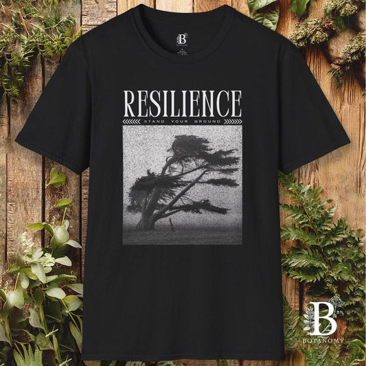Black t-shirt with 'RESILIENCE' graphic and tree design on a wooden background