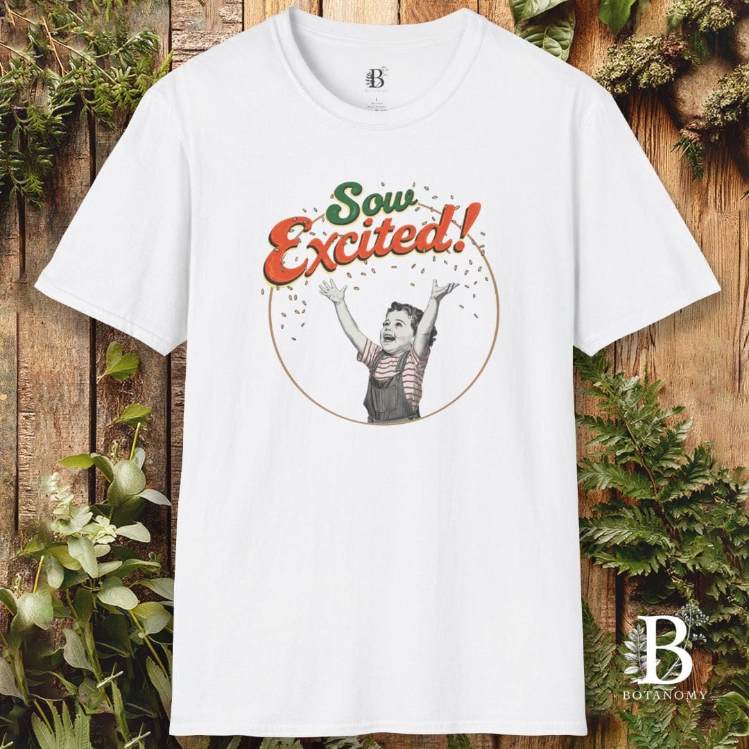 White t-shirt with 'Sow Excited!' graphic on a wooden background with plants