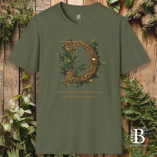 Green t-shirt with decorative design and text on a wooden background with plants