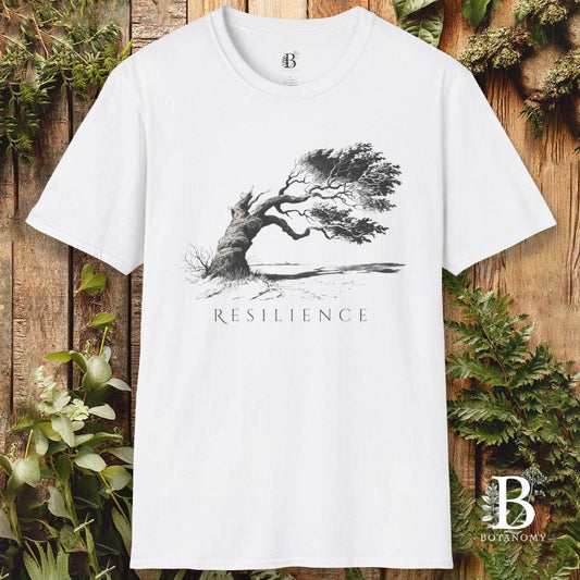 White t-shirt with 'Resilience' graphic and brand logo on a wooden background