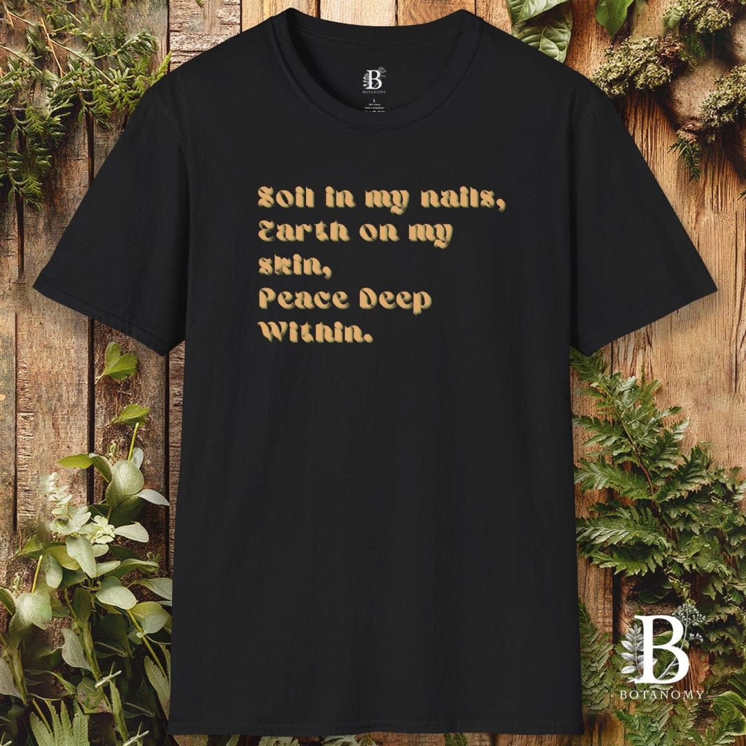 Black t-shirt with gold text on a wooden background