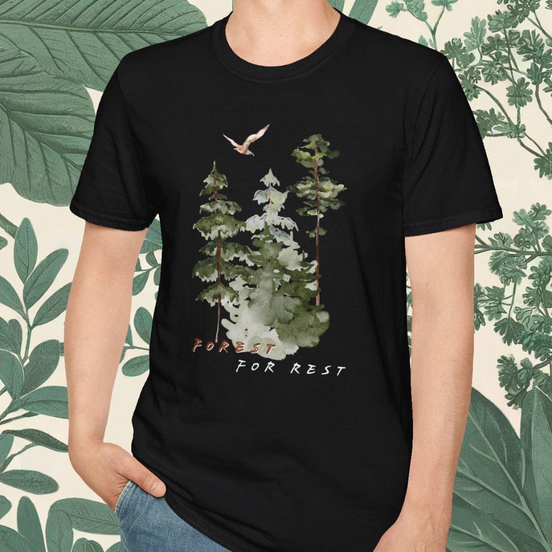 Person wearing a black t-shirt with a nature graphic and text, standing against a leafy background.