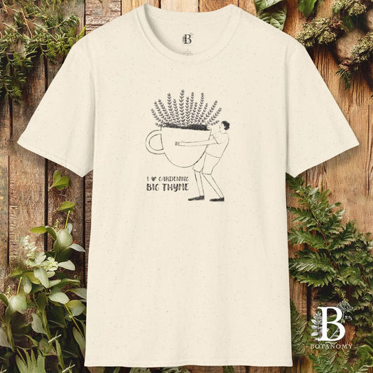 Beige t-shirt with graphic design and text on a wooden background with plants