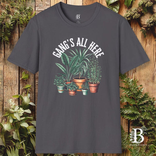 Gray t-shirt with plant graphic and 'Gang's All Here' text on a wooden background