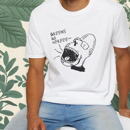 Man wearing a white t-shirt with a graphic design sitting on a white stool against a green leafy background.