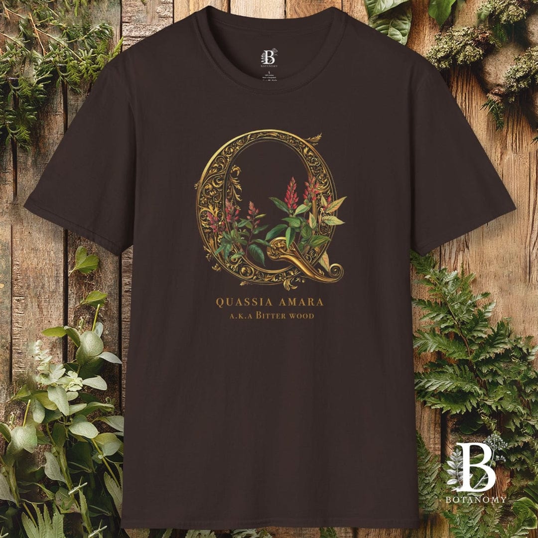 Black t-shirt with decorative 'Q' design and text on a wooden background with plants