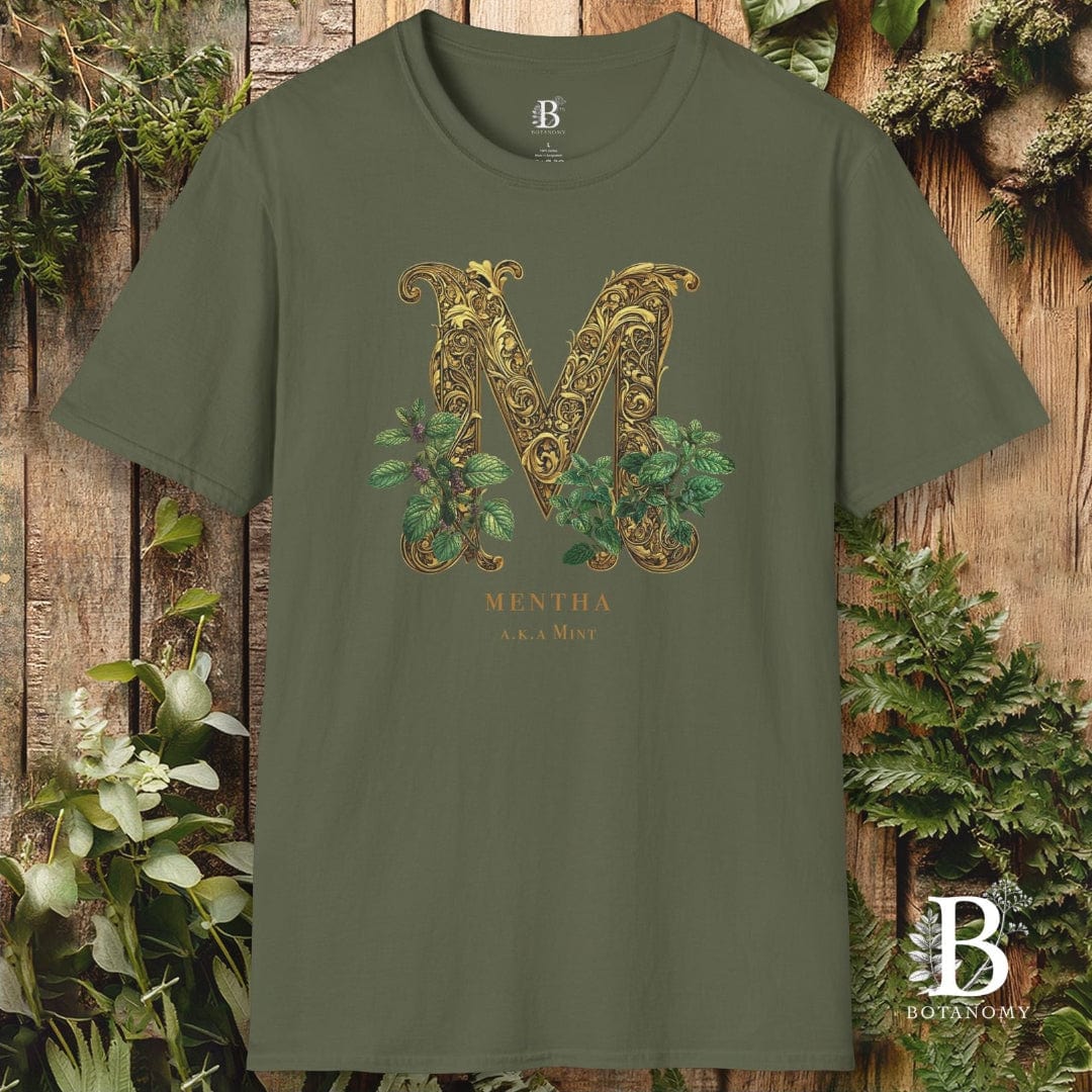 Green t-shirt with decorative 'M' design on a wooden background