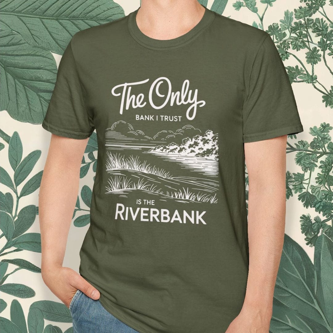 Person wearing a green t-shirt with a nature-themed design and text, standing against a leafy background.