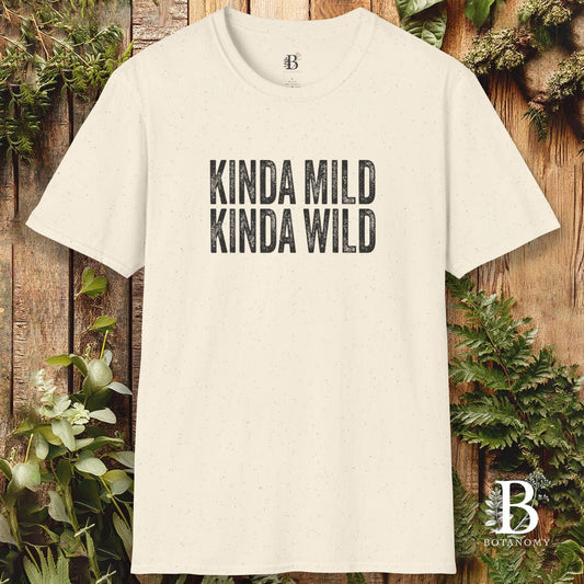 Beige t-shirt with 'KINDA MILD KINDA WILD' text on a wooden background with greenery