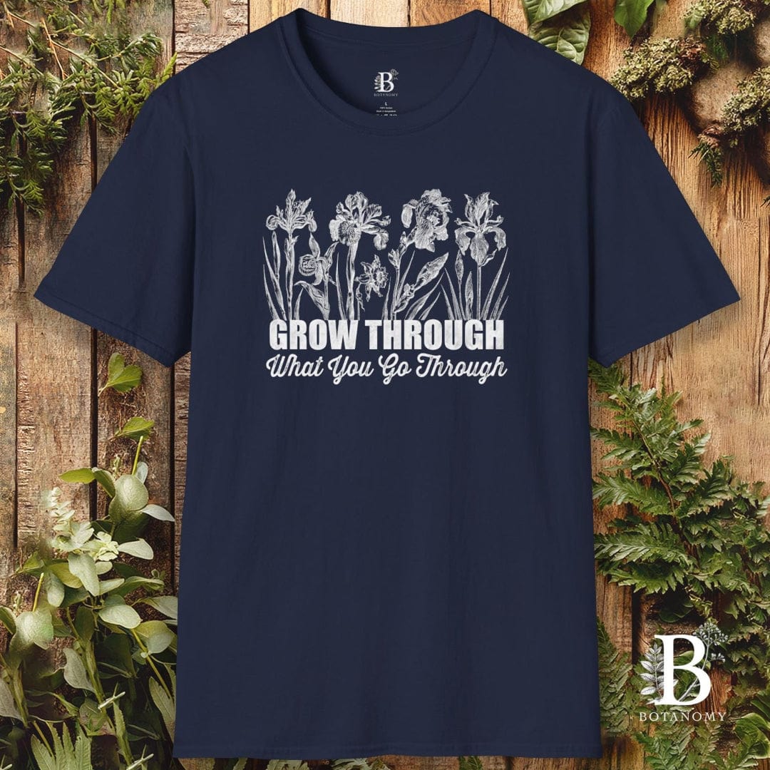 Navy blue t-shirt with white floral design and text on a wooden background