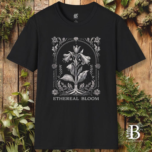 Black t-shirt with floral design and 'Ethereal Bloom' text on a wooden background