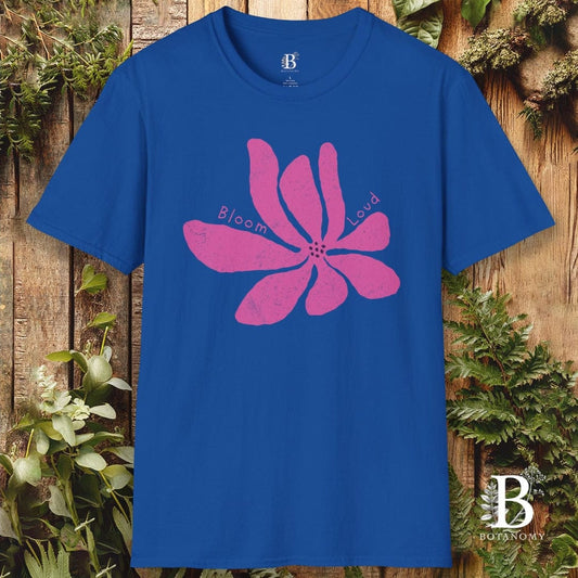 Blue t-shirt with pink floral design and 'Bloom' text on a wooden background