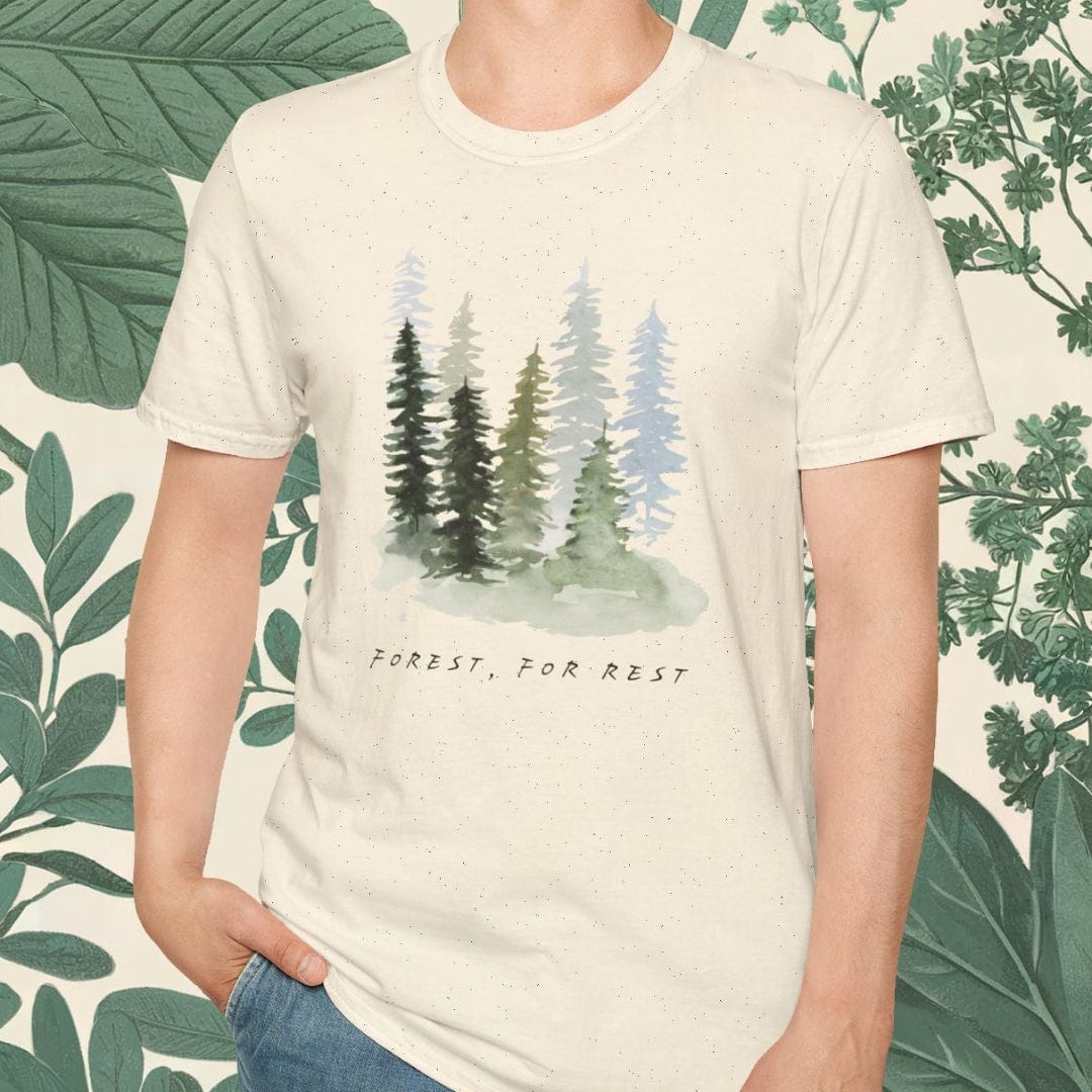 Person wearing a t-shirt with a forest design and text, standing against a leafy background