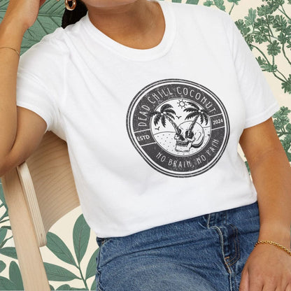 Woman wearing a white t-shirt with a graphic design, sitting on a chair with a floral-patterned background.