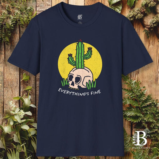 Navy blue t-shirt with a graphic design featuring a skull and cactus, text 'EVERYTHING'S FINE', on a wooden background.