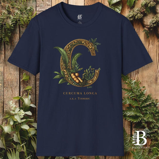 Navy blue t-shirt with gold and green graphic design on a wooden background
