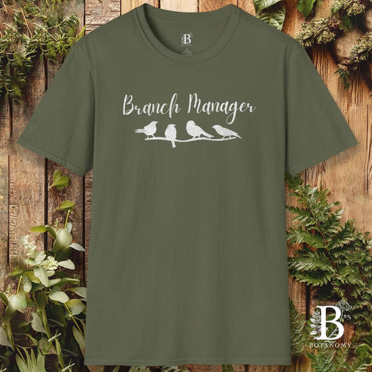 Green t-shirt with 'Branch Manager' and bird design on a wooden background