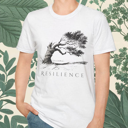 White t-shirt with a tree graphic and 'RESILIENCE' text on a person, against a leafy green background.